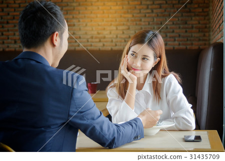 Happy couple looking at each other having lunch Happy couple looking at each other having lunch 31435709