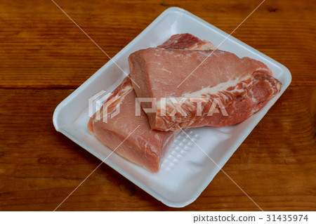 Fresh raw pork tenderloin, meat on wooden cutting Fresh raw pork tenderloin, meat on wooden cutting 31435974