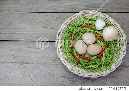 Acacia pennata and egg in basket on wood  31439725