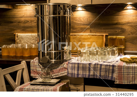 Beekeeper filling up the fresh golden new honey 31440295