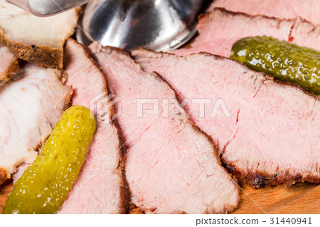 Delicious sliced roast beef with pickled cucumber. Delicious sliced roast beef with pickled cucumber. 31440941