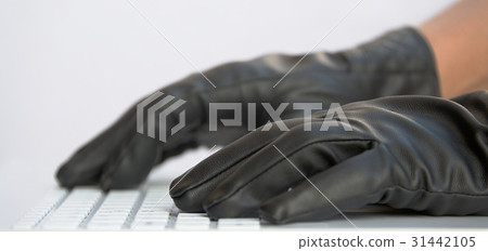 Hacker in black gloves on white computer keyboard Hacker in black gloves on white computer keyboard 31442105