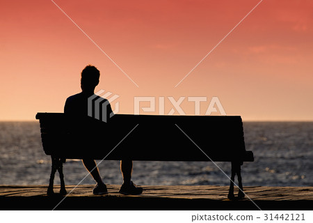 Silhouette of men sitting alone on the bench 31442121