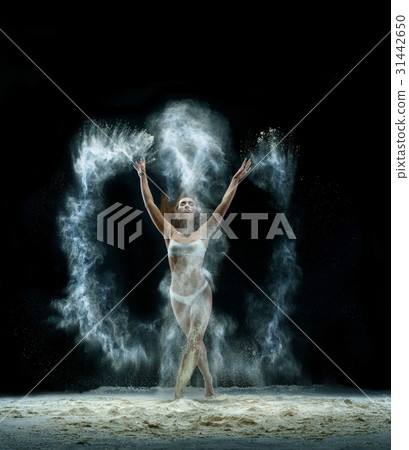 Pretty girl in cloud of white dust studio portrait 31442650