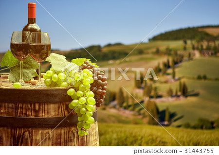 wine bottle and wine glass on wodden barrel. wine bottle and wine glass on wodden barrel. 31443755