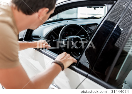 Male watching at up-to-date car interior Male watching at up-to-date car interior 31444024