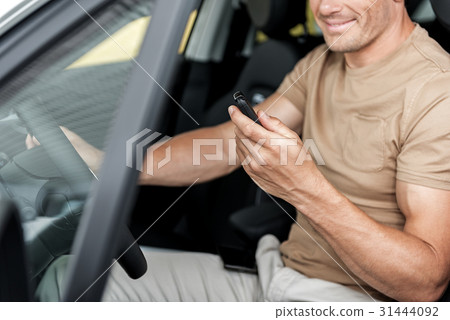 Cheerful man looking at automobile keys 31444092