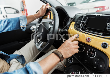 Male hand keeping helm in automobile Male hand keeping helm in automobile 31444195
