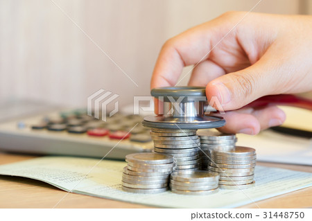 Hands checking financial credit with stethoscopes 31448750