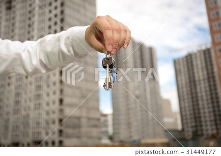 Businessman holding keys from new real estate Businessman holding keys from new real estate 31449177