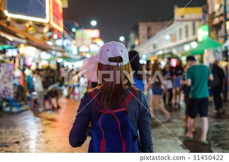 young woman traveler walking in the Khao San road young woman traveler walking in the Khao San road 31450422