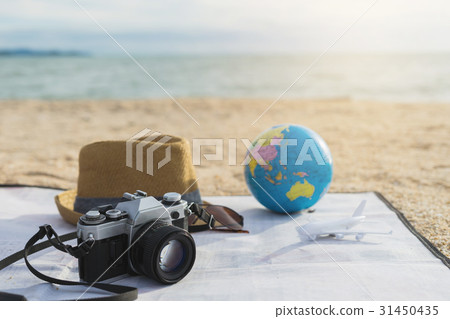 Camera, Hat and sunglasses on the beach Camera, Hat and sunglasses on the beach 31450435