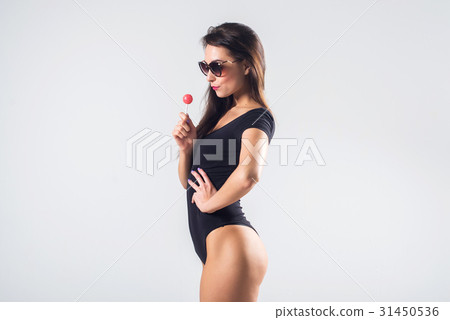 Young brunette model with lollipop studio shot on Young brunette model with lollipop studio shot on 31450536