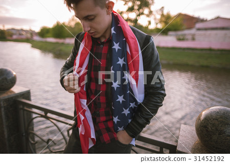 Tired USA patriot holds national flag Tired USA patriot holds national flag 31452192