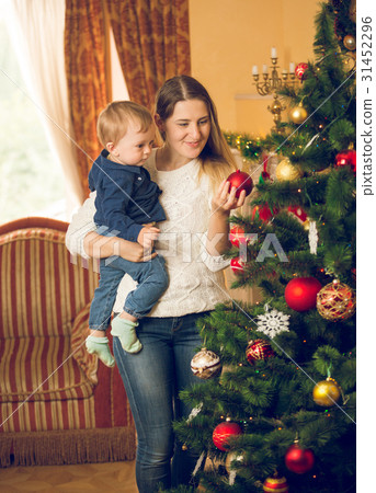 mother with 10 months old baby son decorating mother with 10 months old baby son decorating 31452296