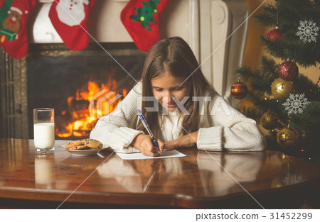 smiling girl sitting by the fireplace smiling girl sitting by the fireplace 31452299