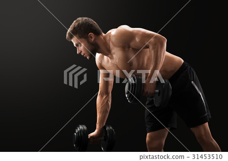 Muscular young man exercising with dumbbells 31453510