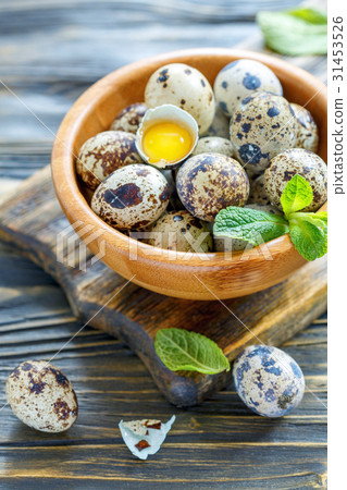 Bowl of quail eggs and the yolk in the shell. Bowl of quail eggs and the yolk in the shell. 31453526