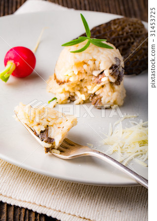 Delicious mushroom risotto with parmesan cheese Delicious mushroom risotto with parmesan cheese 31453725