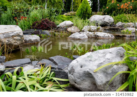 Water flowing through rocks in formal garden Water flowing through rocks in formal garden 31453982