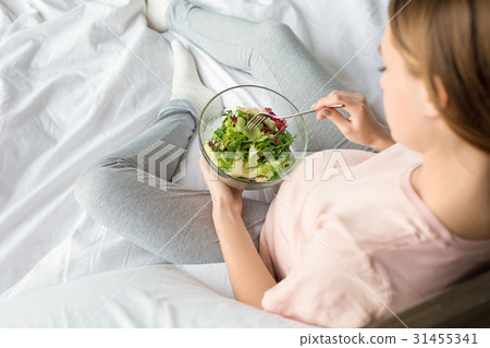 Young preganant woman expecting a baby relaxing on 31455341