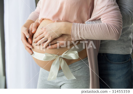 Young couple expecting baby standing together 31455359