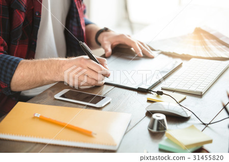 Young man architect working in the office Young man architect working in the office 31455820
