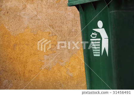 old green bins beside grunge yellow walls. old green bins beside grunge yellow walls. 31456491