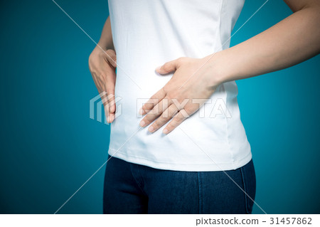 A woman putting her hands on her stomach A woman putting her hands on her stomach 31457862