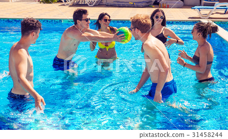 Group of cheerful couples friends playing water Group of cheerful couples friends playing water 31458244