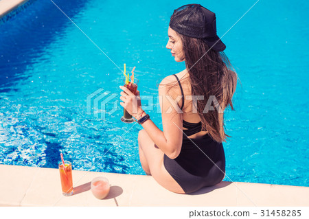 young sexy girl at swimming pool Drinking cocktail 31458285