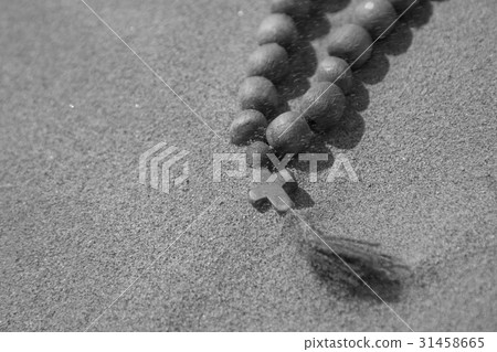 A wooden cross lies on the sand A wooden cross lies on the sand 31458665