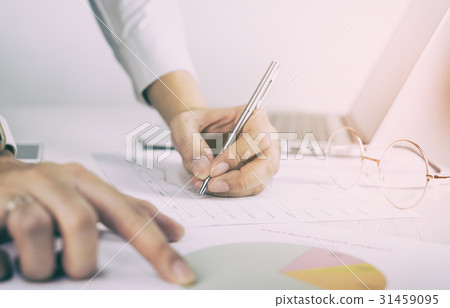 Business man is analysing data on his documents Business man is analysing data on his documents 31459095