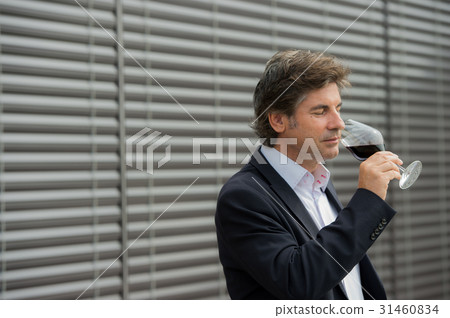 Portrait confidant vintner drinking red wine in winery Portrait confidant vintner drinking red wine in winery 31460834