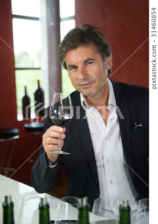 Portrait confidant vintner drinking red wine in winery 31460854