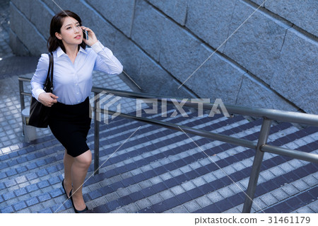 A woman ascending a staircase 31461179