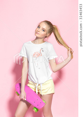 Woman holding small skateboard 31463453
