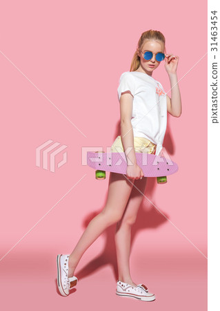 Woman holding small skateboard 31463454