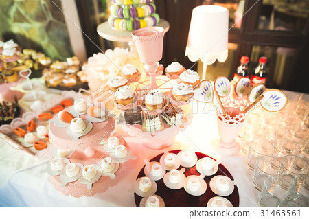 Delicious and tasty dessert table with cupcakes 31463561