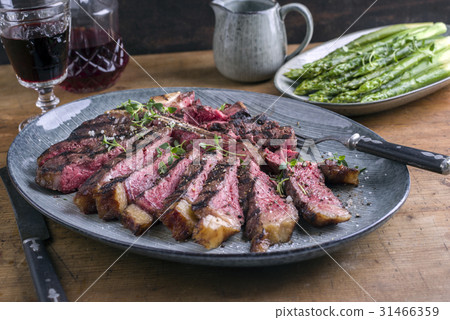 Wagyu T-Bone Steak with Green Asparagus on Plate 31466359