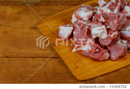 raw pork meat slices on a wooden board raw pork meat slices on a wooden board 31468762