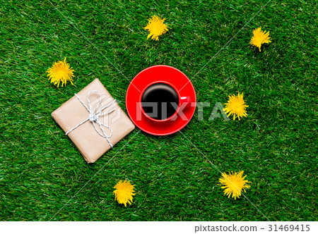 gift and cup of coffee on grass gift and cup of coffee on grass 31469415