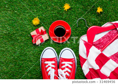 gumshoes, jacket on hanger, gift and cup of coffee gumshoes, jacket on hanger, gift and cup of coffee 31469456