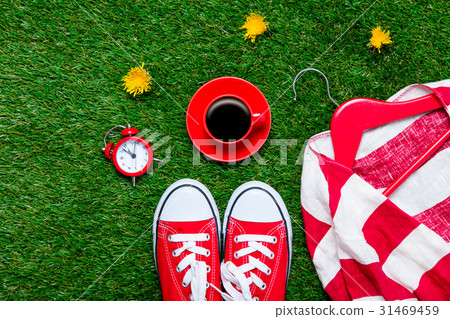 gumshoes, jacket on hanger, alarm clock 31469459