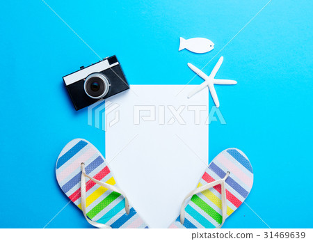 sandals, sheet of paper, camera, starfish and toy 31469639