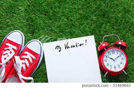 gumshoes, sheet of paper and alarm clock 31469665