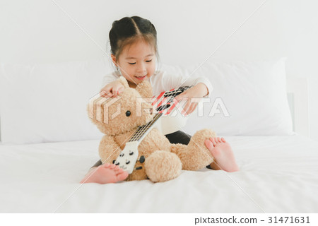 asian sweet little girl is playing with teddy bear asian sweet little girl is playing with teddy bear 31471631
