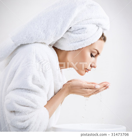 Young woman washing face with clean water. Young woman washing face with clean water. 31473706
