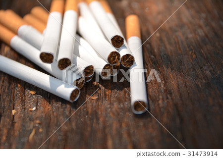 Tobacco cigarettes on wooden background Tobacco cigarettes on wooden background 31473914