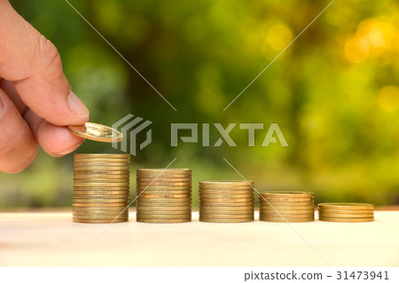 Saving money concept hand putting money coin stack Saving money concept hand putting money coin stack 31473941